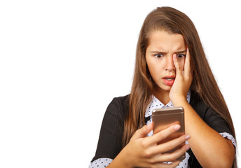 Fototapeta premium indignant teen girl looks at smartphone display