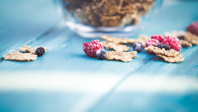Organic cereals on blue wooden background