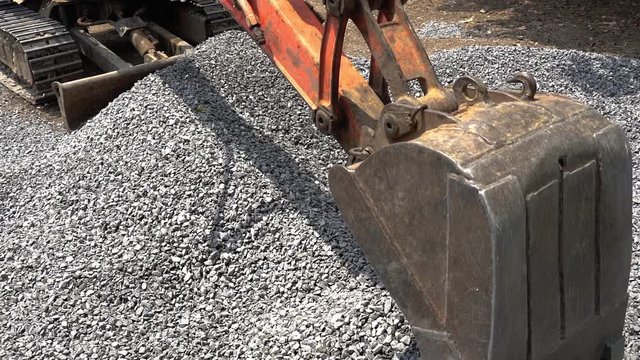 Excavators are digging stones for the construction or repair of roads in rural areas background.