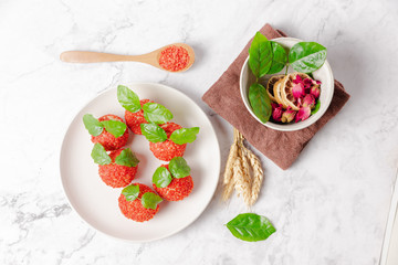 Red dessert like litchi on a white plate