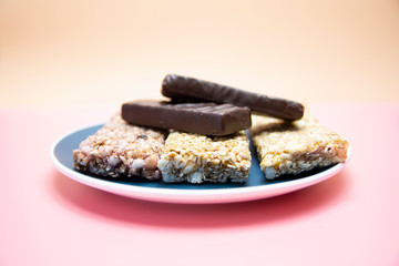 healthy nutrition protein bars on pink and orange background