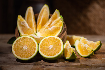 Beautiful color of green orange, on the  wooden table indoor © chen