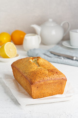 Lemon bread. Cake with citrus and poppy on cutting board, traditional american cuisine. Whole loaf