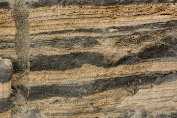 background of cross section dirty sand layers in nature beach