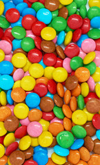 Fototapeta na wymiar vertical background many colored small candies