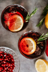 Pomegranate drink in a glass with lemon and rosemary