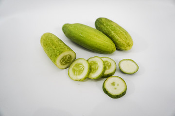fresh cucumber sliced on a white background