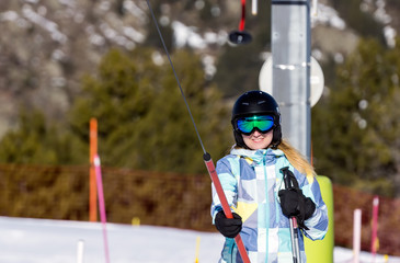 Selective focus on Caucasian white woman, skier riding up on draglift. Winter holidays in El Tarter, Grandvalira, Andorra