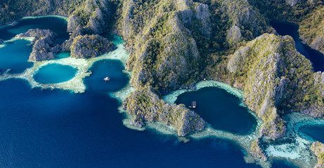 View from above, stunning aerial view of the Twin Lagoons surrounded by rocky cliffs. The Twin Lagoons are one of the must-see destinations in Coron Island. Palawan, Philippines.