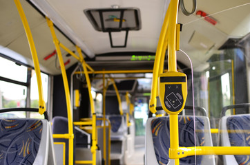 Automatic validator for reading and scanning ticket, cards and bank cards in public transport to pay for riding. Wireless contactless cashless payments, rfid nfc. Salon bus of the urban vehicle