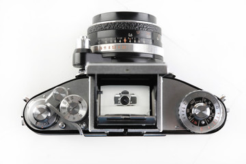 The old German 35 mm SLR film camera with Lens 2,8 50 mm on a white background.