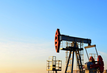 Oil drilling derricks at desert oilfield for fossil fuels output and crude oil production from the...