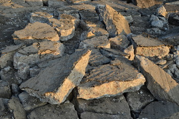 Broken pieces of asphalt at a construction site. Recycling and reuse crushed concrete rubble, asphalt, building material, blocks. Crushed сoncrete Background. Road repair, replacement of old pavement