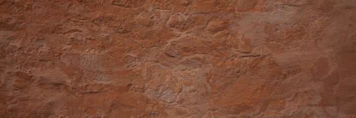 Panoramic texture of a plain wall painted with brown color. Panoramic brown background