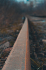 Railway crossing on a cloudy day. Traveling by train. Shallow depth of field