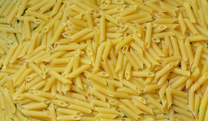 Macaroni background. Dry raw pasta.