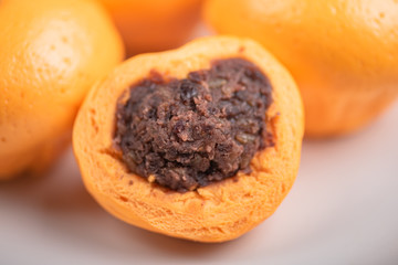 Pork dumpling in cartoon style,Pork bun like an orange in a white plate on the indoor dining table