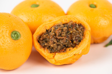 Pork dumpling in cartoon style,Pork bun like an orange in a white plate on the indoor dining table
