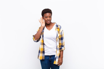 young pretty black womanlooking serious and curious, listening, trying to hear a secret...