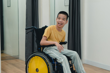 Disabled child on wheelchair having fun shopping for clothes, He is in front of fitting room,Special children's lifestyle,Life in the education age of special need kids,Happy disability kid concept.