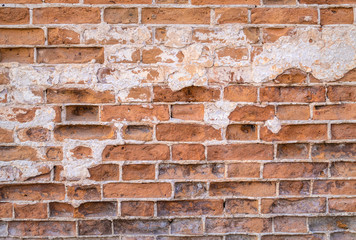 Old cracked red brick wall