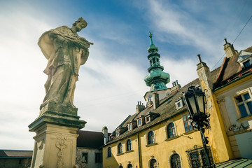 Fototapeta na wymiar Ancient sculpture of Jan Nepomucky near Michal Gate in Bratislava, Slovakia
