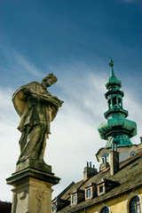 Fototapeta na wymiar Ancient sculpture of Jan Nepomucky near Michal Gate in Bratislava, Slovakia