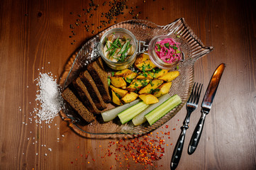 Top view of plate with fried potatoes with pickled mushrooms