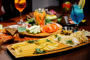 Many different delicious dishes on the table. Various snacks and antipasti on the table. Restaurant menu.