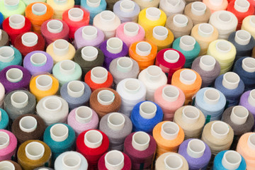 Sewing threads multicolored background closeup