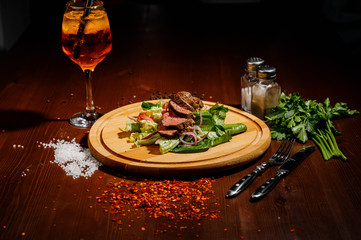 ham with lettuce on a wooden board on a table