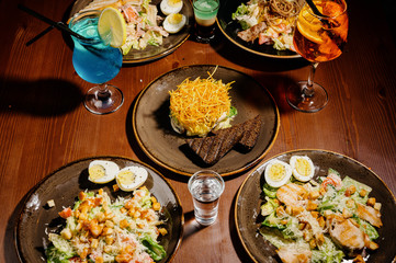 Many different delicious dishes on the table. Various snacks and antipasti on the table. Restaurant menu.