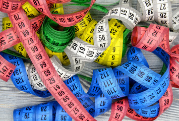 measuring tape on wooden background