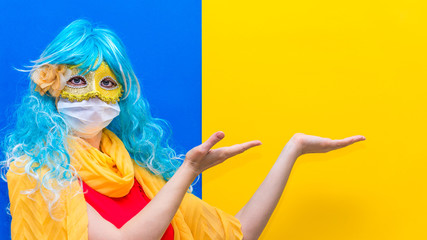 Concept of protection against coronavirus at carnival venice. A bright woman in a blue wig and...