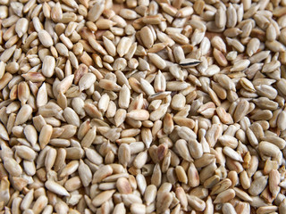 Sunflower seeds peeled on a wooden table, top view.