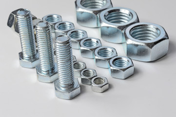 Bolts and screw-nut of different sizes. Concept. White background.