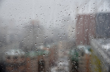 The view from the window through the misted window. Raindrops.