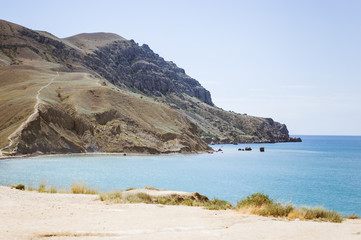 Fototapeta na wymiar Meganom mountain range and beach, as well as the peninsula and cape in southeastern Crimea between