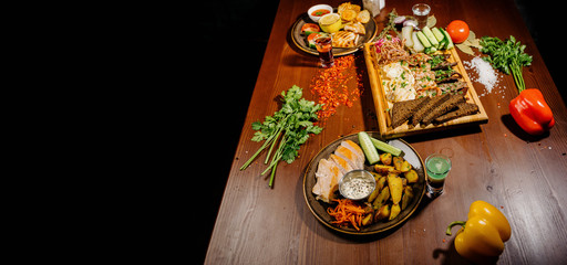 Many different delicious dishes on the table. Various snacks and antipasti on the table. Restaurant menu.