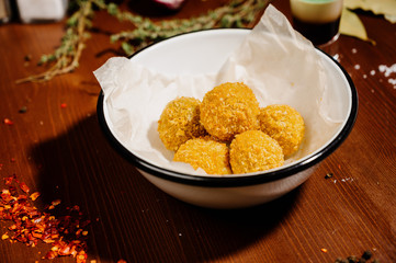 potato croquette balls with sauce on a plate.