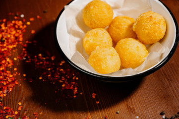 potato croquette balls with sauce on a plate.