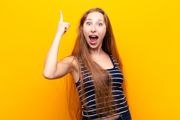 yound blonde woman feeling like a happy and excited genius after realizing an idea, cheerfully...
