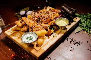 Selection of beer and snacks.Chips, fish, beer sausages on the table