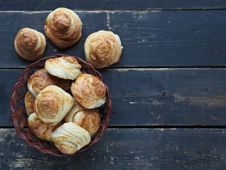 Homemade buns buns rich in a natural plate of vines on a dark wooden background. Holiday and...