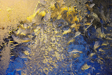 Winter background, frost and ice crystals on window glass