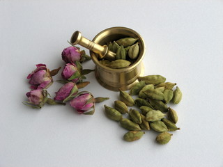 Whole cardamom pods and mortar on with background. Flowers concept is aromatic spice. Close up.