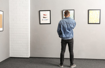 Man at exhibition in modern art gallery