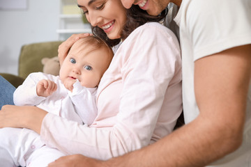 Obraz na płótnie Canvas Cute baby with parents at home