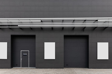 Obraz na płótnie Canvas Black wall of the building with doors, emergency exits