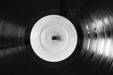 Black and white photo of spinnig vinyl record